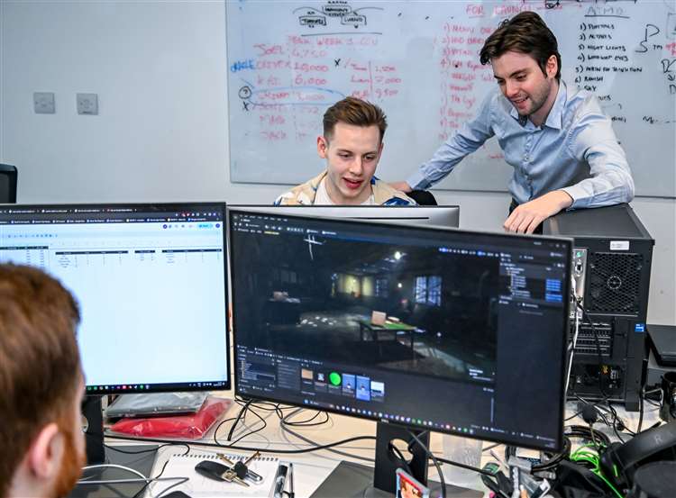 Working at World Makers, reviewing a build in Unreal Engine with a teammate